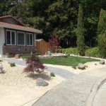 Landscaped front yard with brick wall