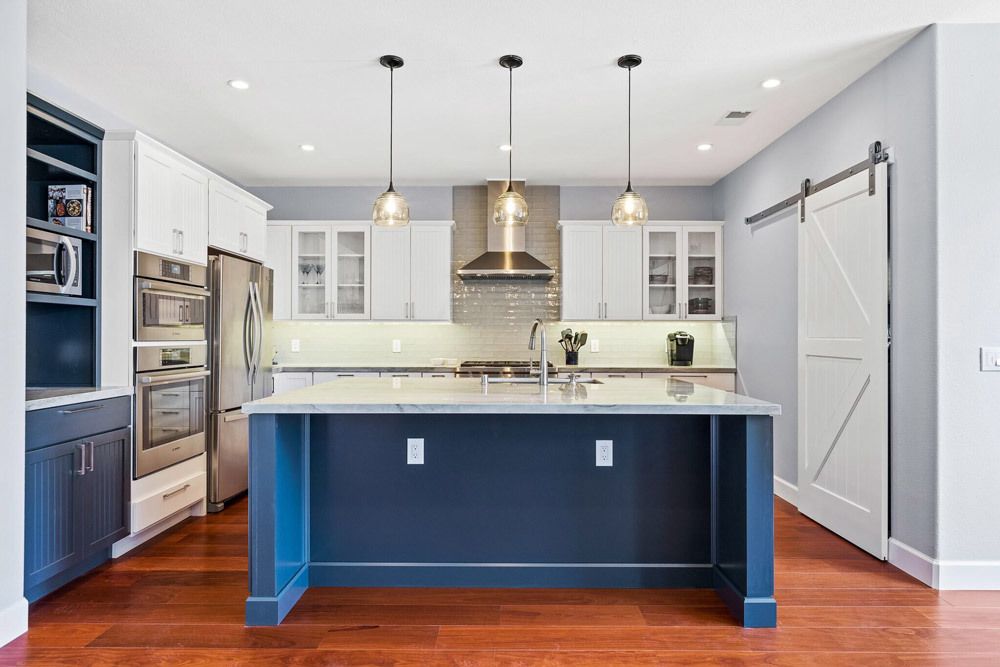 Kitchen remodel: island counter top, overhead lighting and appliances.