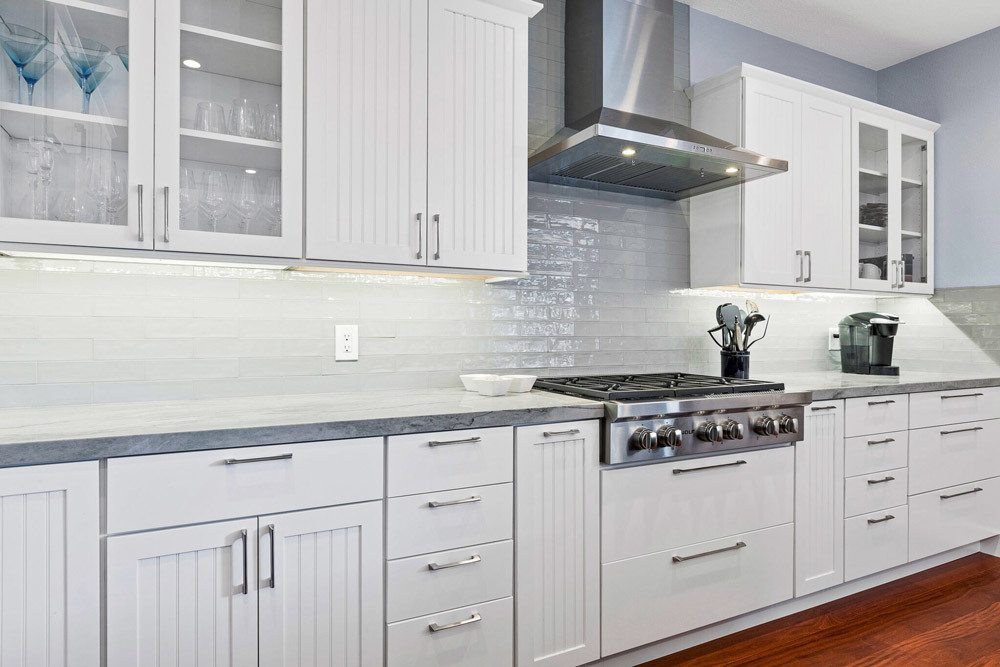 Kitchen remodel: Stove top and clean white cupboards.