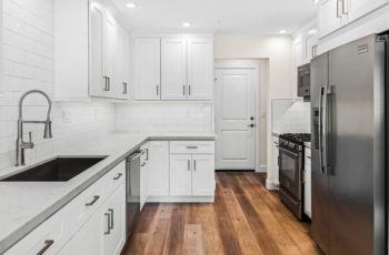 White decor interior of home with kitchen cabinets.