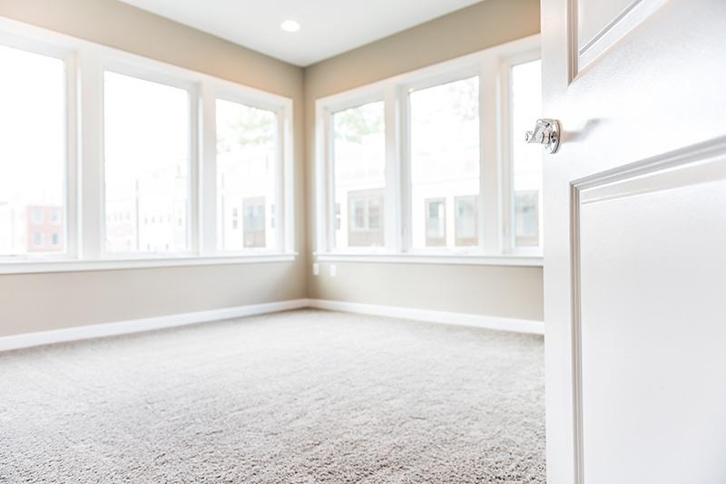 door opening into room with new carpet and lots of windows