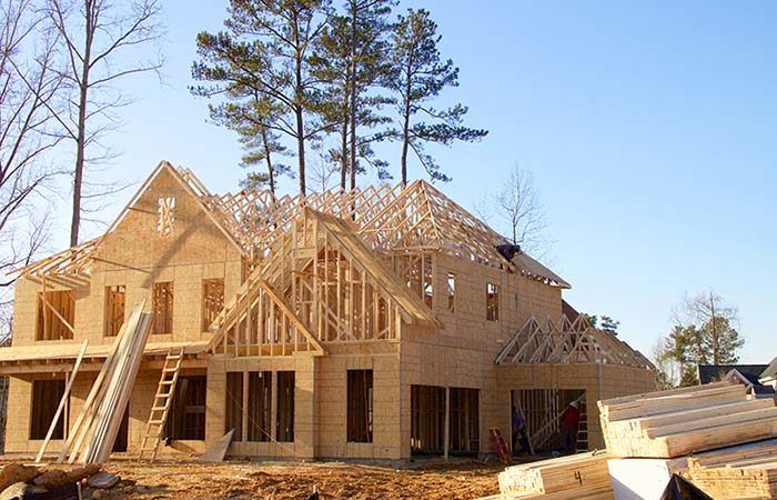 wood structure of a new house under construction on a sunny day