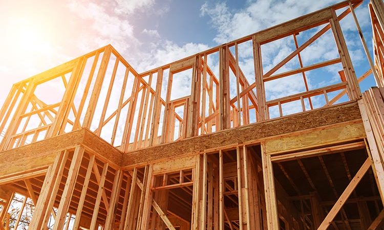 New residential construction home framing against a blue sky. Roofing construction. Wooden construction