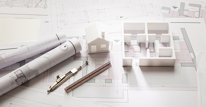 Blueprints and floorplan models on a desk