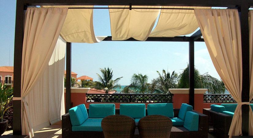 a beautiful covered patio with plush outdoor furniture on a sunny day