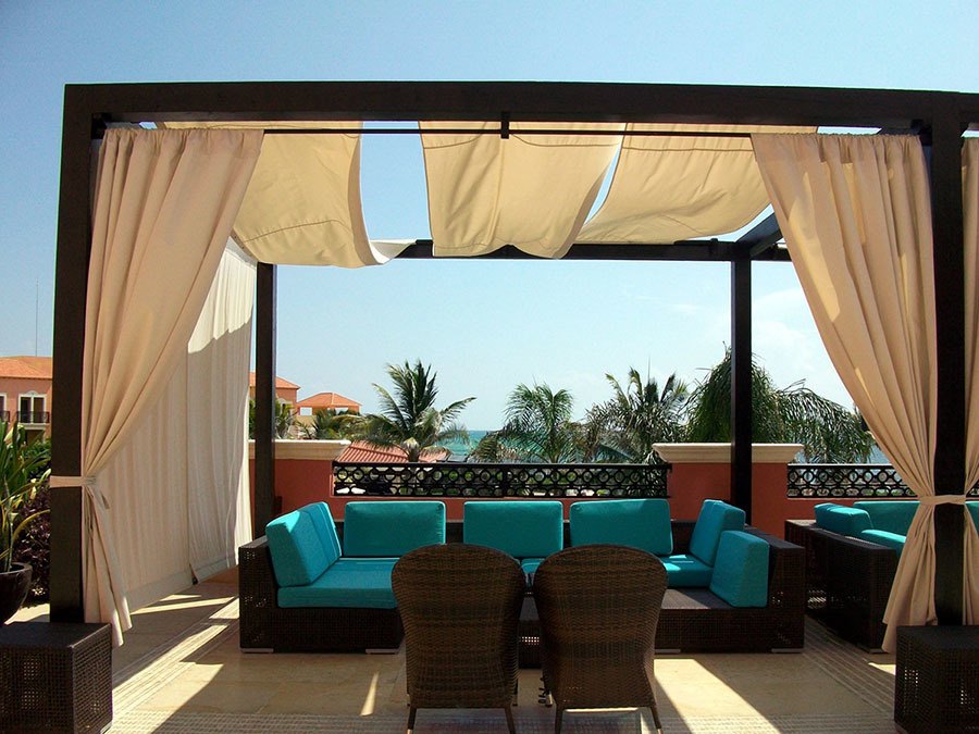 a beautiful covered patio with plush outdoor furniture on a sunny day