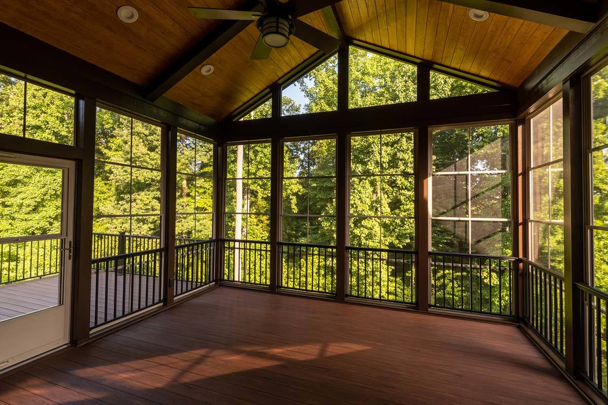 Enclosed deck home addition with trees outside windows