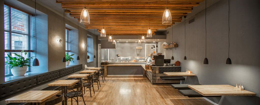 well lit empty restaurant, light shining off wood floor