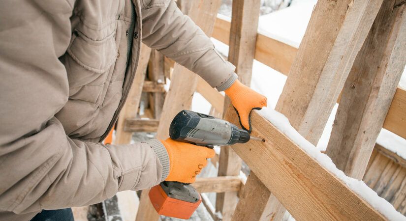 Carpenter framing house in winter jacket