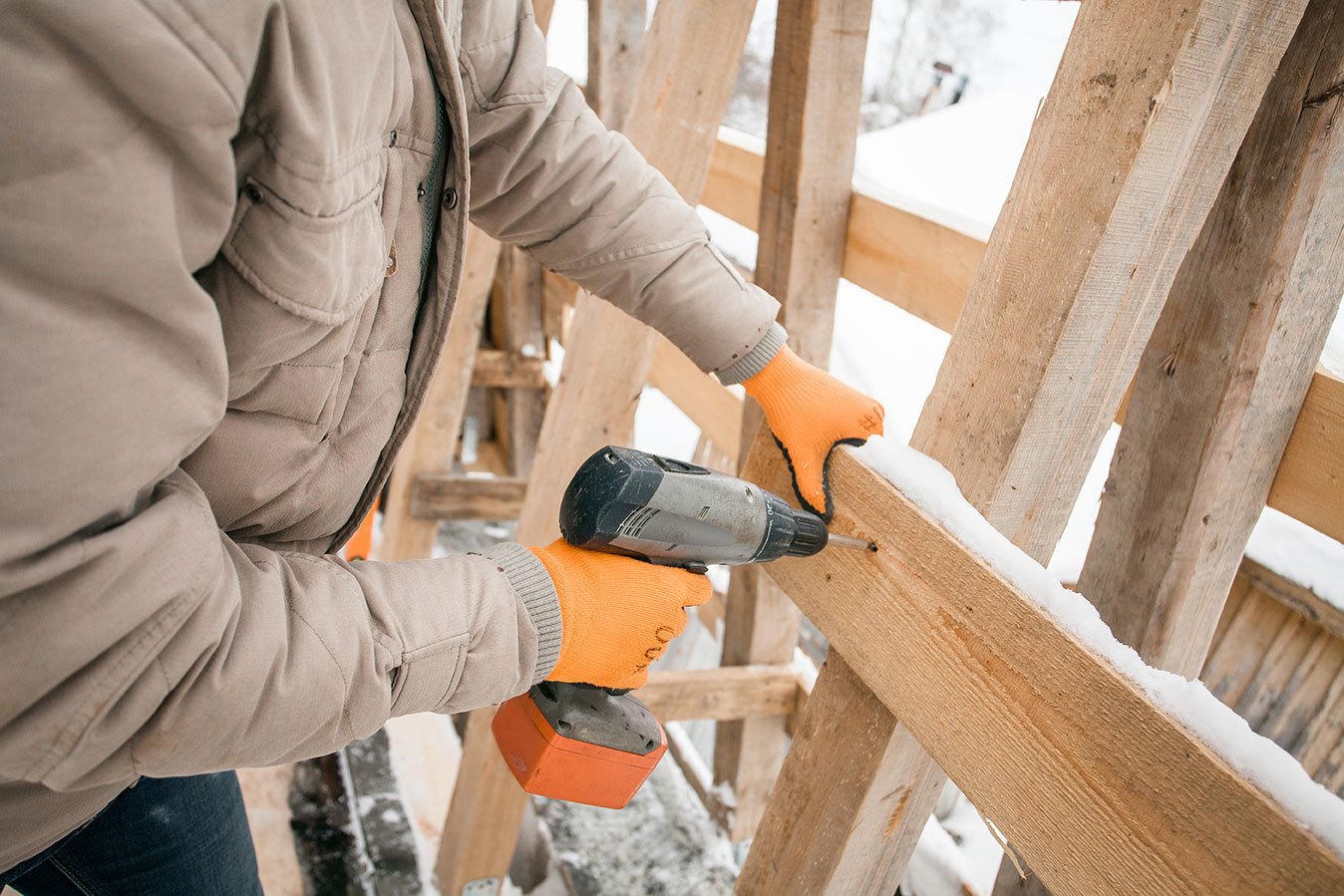 Carpenter framing house in winter jacket