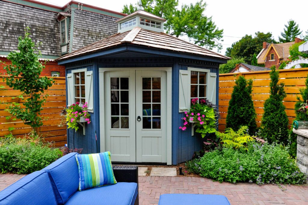 newly built poolhouse on patio in backyard