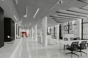 Large white room with many round white pillars and acoustic panels in parts of the ceiling.