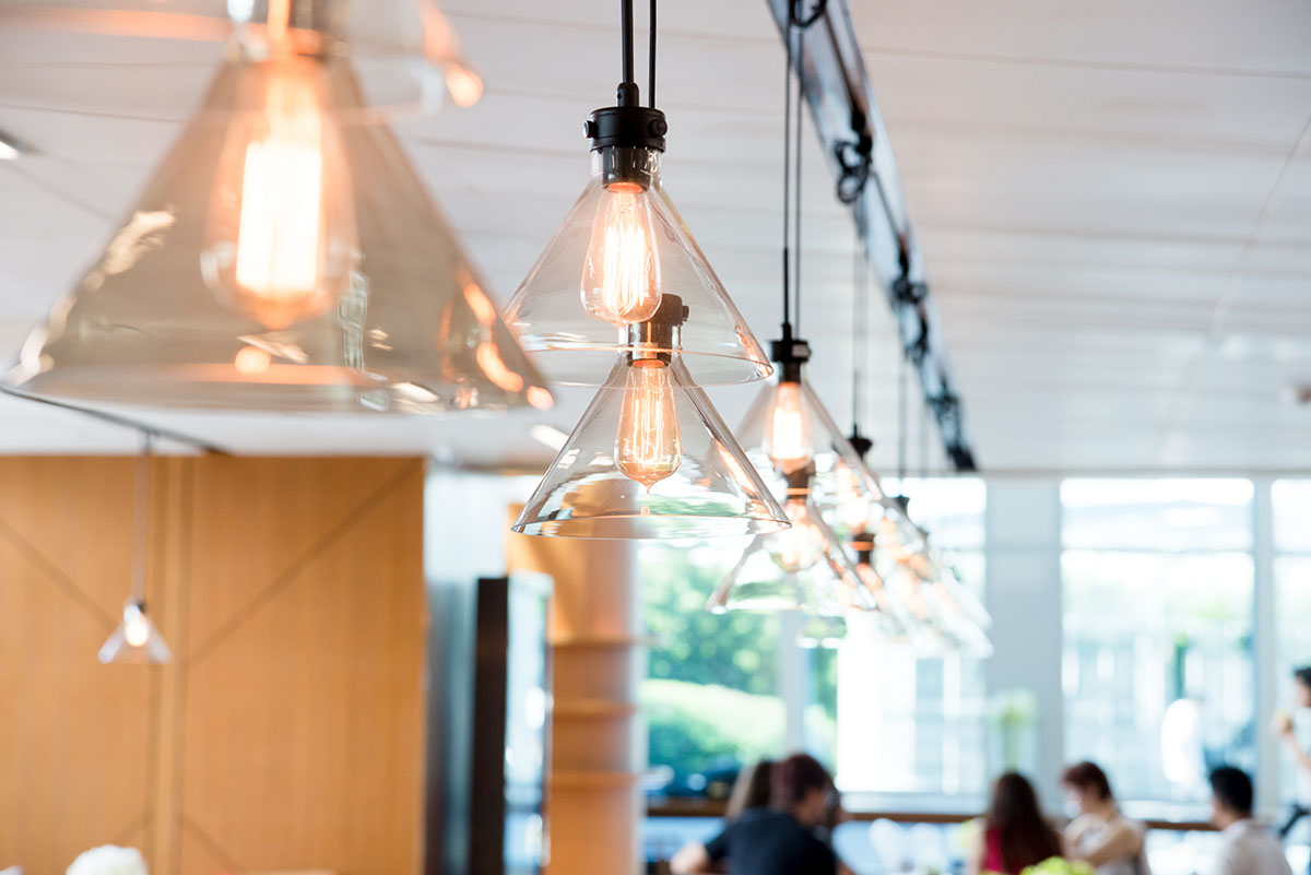 Modern lighting fixtures hang in a commercial office space.