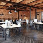 The interior of a modern commercial office building with brick walls that's been newly remodeled.