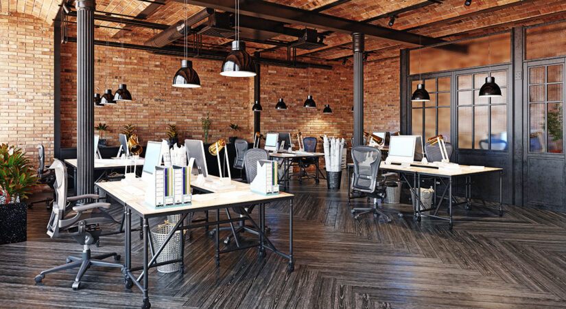 The interior of a modern commercial office building with brick walls that's been newly remodeled.