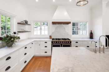 A newly renovated kitchen with white countertops and an antique stove, showing the concept of eco-friendly home renovations